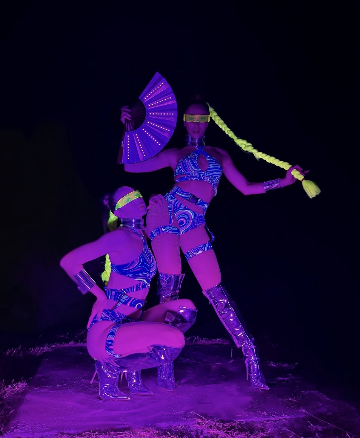 UV neon performers with fans and glowing costumes