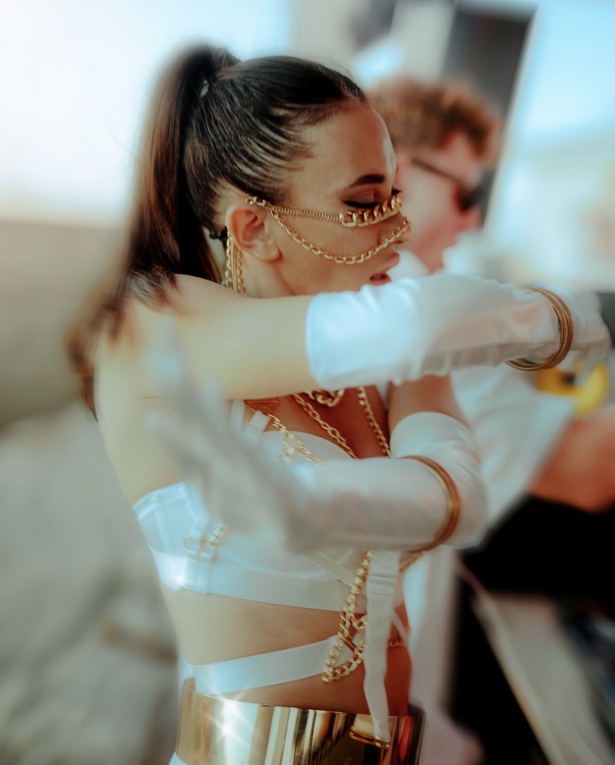 Performer in white and gold chain costume
